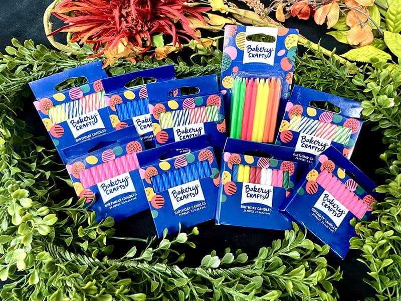 Packs of colorful birthday candles available at the counter.